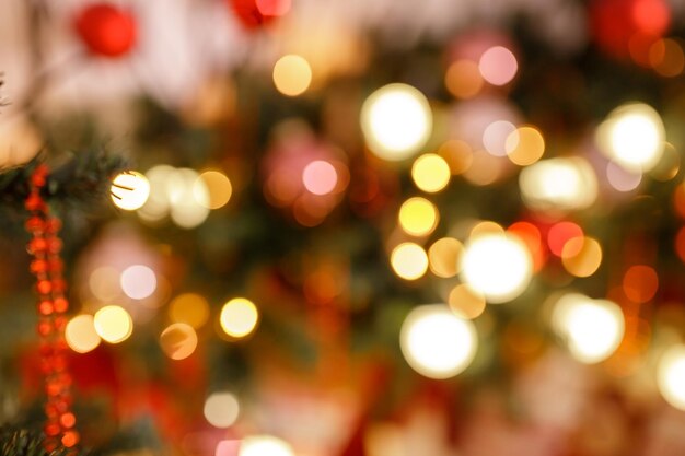 Beautiful holiday decorated room with Christmas tree and bright lights out of focus