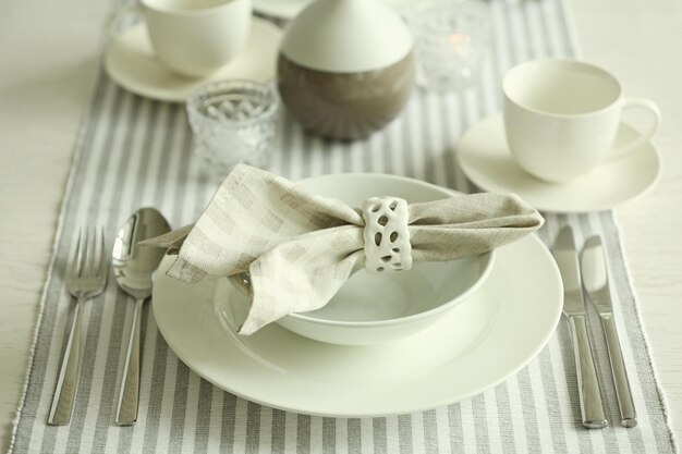 Beautiful holiday table setting in white and gray color