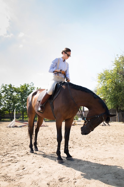 Beautiful horsewoman, in full growth