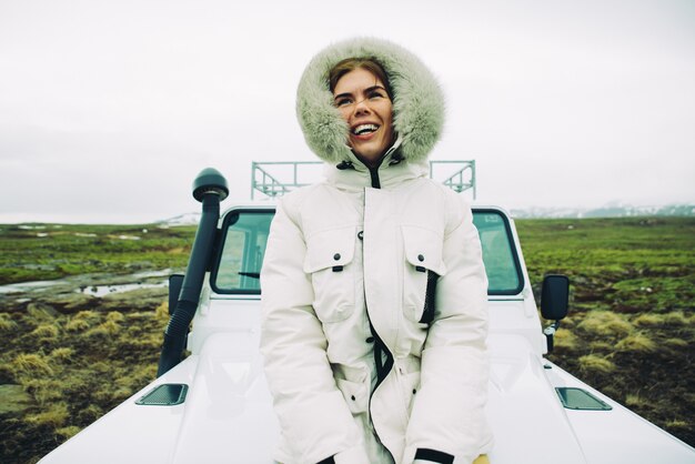 Beautiful icelandic girl enjoying the landscape in Iceland ,looking out the car window