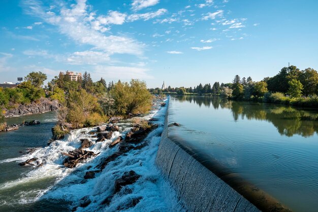 Beautiful Idaho waterfall meeting snake river near temple with sky in background