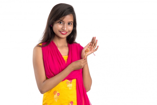 Beautiful Indian girl showing Rakhis on occasion of Raksha bandhan. Sister tie Rakhi as symbol of intense love for her brother.