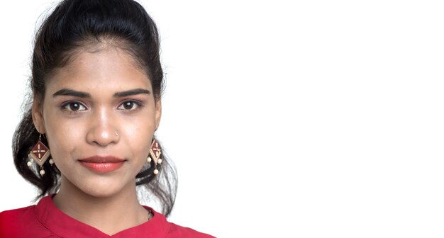 Beautiful Indian traditional girl posing on white wall.