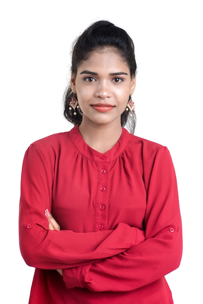 Beautiful Indian traditional girl posing on white wall.