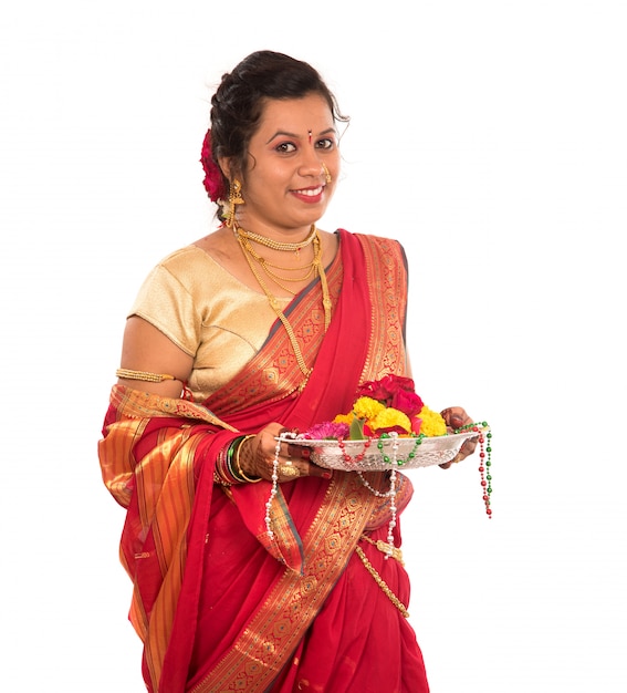 Beautiful Indian woman holding flower thali