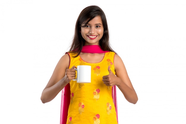 Beautiful Indian woman in a traditional costume with a cup of coffee