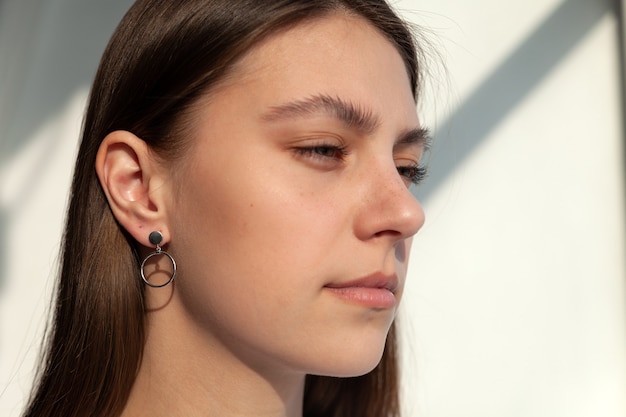 Beautiful jewelry model in modern silver round minimal earrings