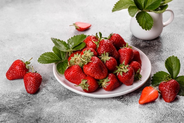 Beautiful juicy fresh strawberries on the concrete surface of the table