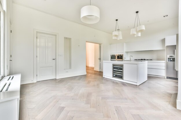 Photo beautiful kitchen in new luxury home with island pendant lights hardwood floors and stainless steel appliances