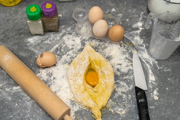 Beautiful kitchen table on which there is a preparation of dough from flour of eggs of milk The concept of making dough