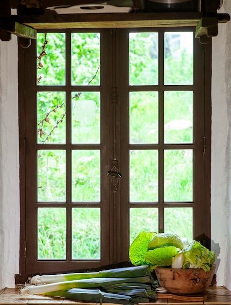 Photo beautiful kitchen wooden window in summer with vegetables on the windowsill