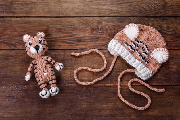 Beautiful knitted tiger from threads. Toy made with your own hands in the year of tiger 2022