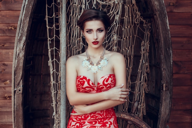 Beautiful lady in red dress in the restaurant.