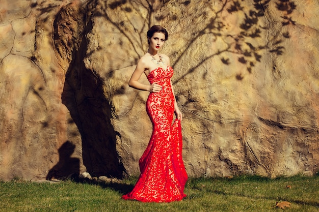 Beautiful lady in red dress in the restaurant.