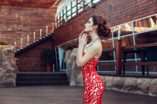 Beautiful lady in red dress in the restaurant.