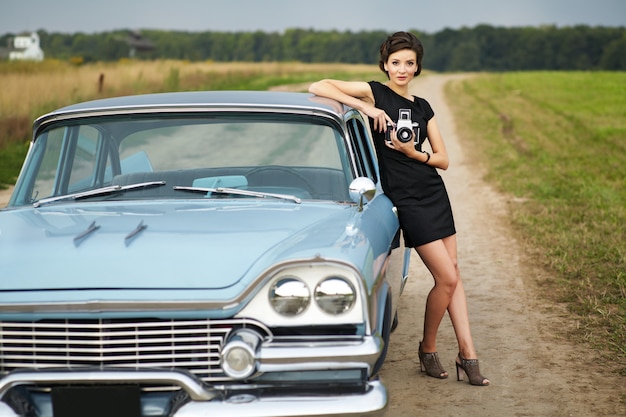 Beautiful lady sitting in a retro car