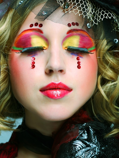 Beautiful lady with artistic make-up.Doll style.