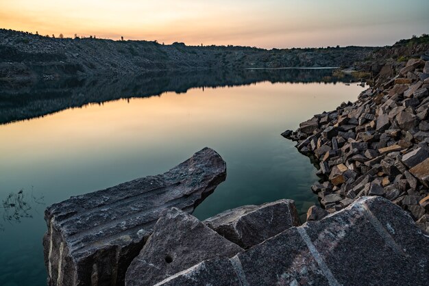 Beautiful lake surrounded by large piles of stone