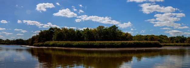 Beautiful landscape over a calm lake clouds river sky sun