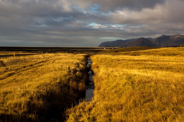 Beautiful landscape image of Iceland with mountains blue sky and green grass