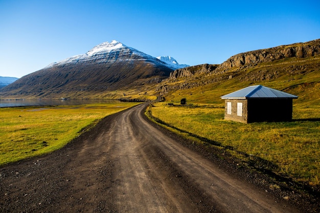 Beautiful landscape image of Iceland with mountains blue sky and green grass