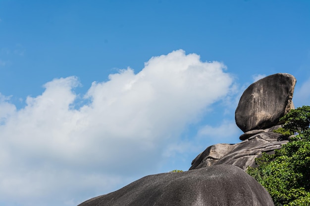 Beautiful landscape people on rock is a symbol of Similan Islands, blue sky and cloud over the sea during summer at Mu Ko Similan National Park, Phang Nga province, Thailand