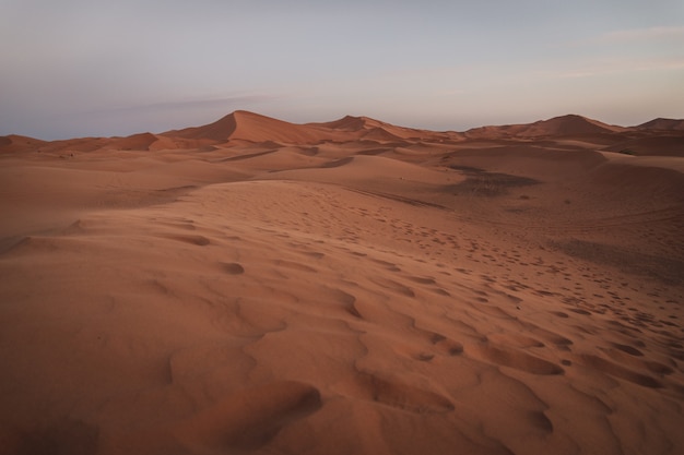 A beautiful landscape of the sand dunes in the Sahara desert in Morocco. Travel photography.