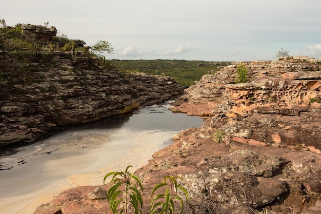 Beautiful landscape of a waterfall full of rocks and water on a cloudy day