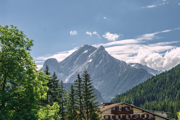 Beautiful landscape with building near rocky mountain