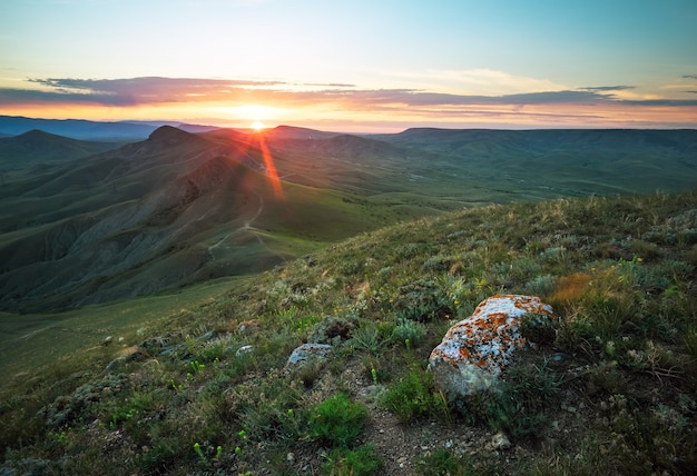 Beautiful landscape with stones and sunset sky. Evening scene in a mountains