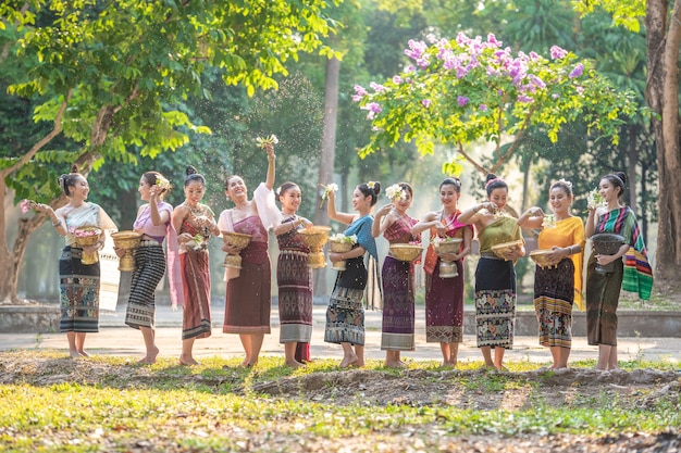 Beautiful Lao girl In the native dress Splashing water during the Lao Vientiane traditional festival 