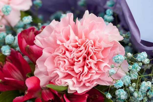 A beautiful large bouquet with multicolored flowers of blue pink red flowers flowers have defects