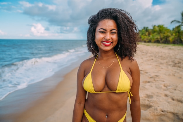 Beautiful Latin American woman in bikini on the beach