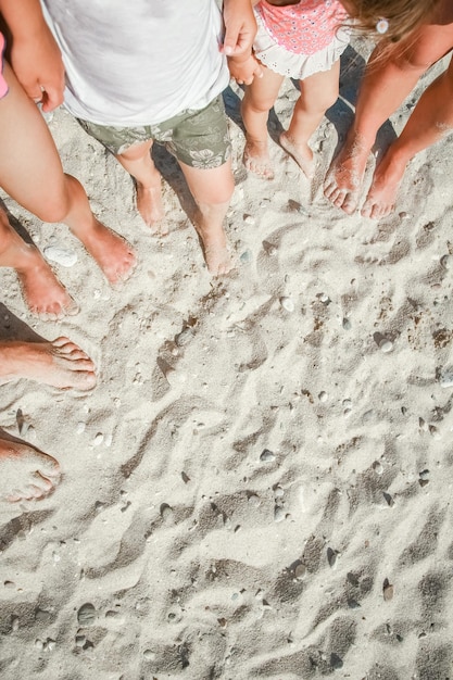 Beautiful legs on the sand by the sea