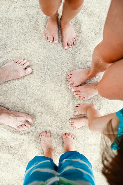 Beautiful legs in the sand of the sea greece background