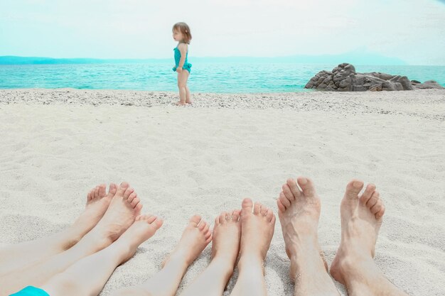 Beautiful legs in the sand of the sea greece background