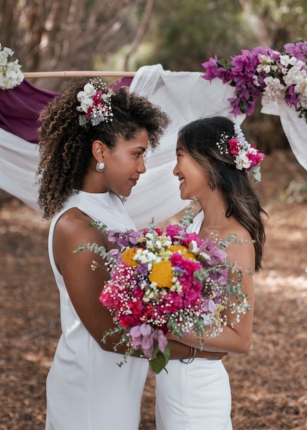 Beautiful lesbian couple celebrating their wedding day outdoors