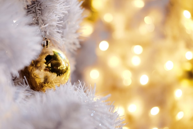 Beautiful lighting and Gold balls decorated hanging on White Christmas Trees Celebration w