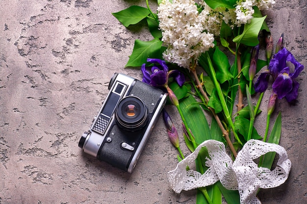 Beautiful Lilac Flower and old camera On Gray Concrete