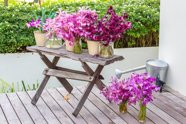 Beautiful lilac pink orchids in a vase in tropical garden outdoors nature concept Exotic colorful orchid bouquet