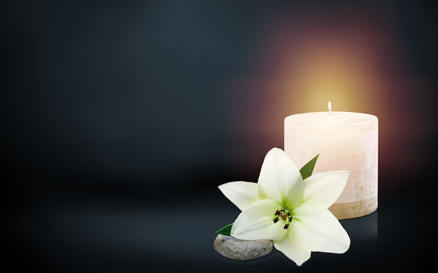 Photo beautiful lily and burning candle on dark background with space for text. funeral flower