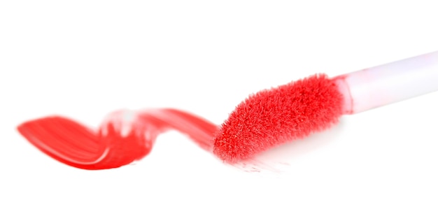 Beautiful lip gloss and brush isolated on white