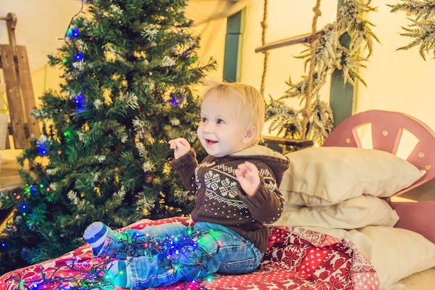 Beautiful little baby celebrates Christmas. New Year's holidays