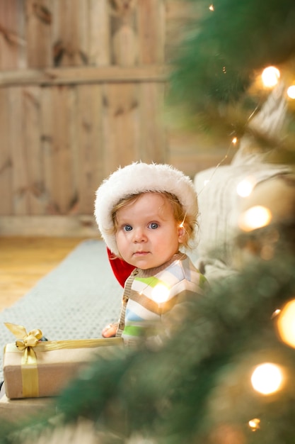 Beautiful little baby celebrates Christmas. New Year's holidays.