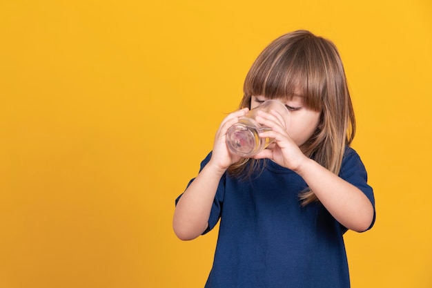 Beautiful little caucasian girl drinking water Hydration and health concept