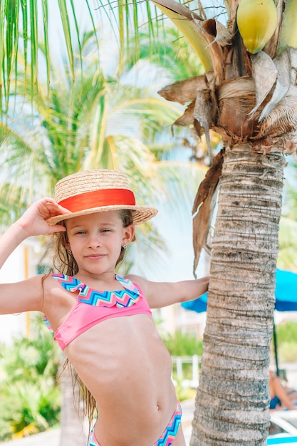 Beautiful little girl at beach having fun. Funny girl enjoy summer vacation.