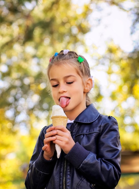 美しい少女は秋にアイスクリームを食べる