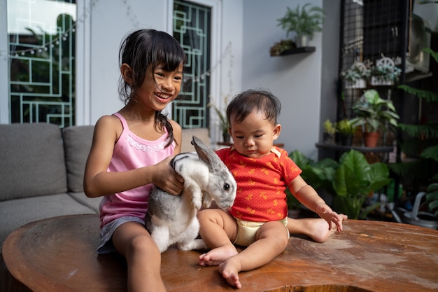 Beautiful little girl holding a funny bunny