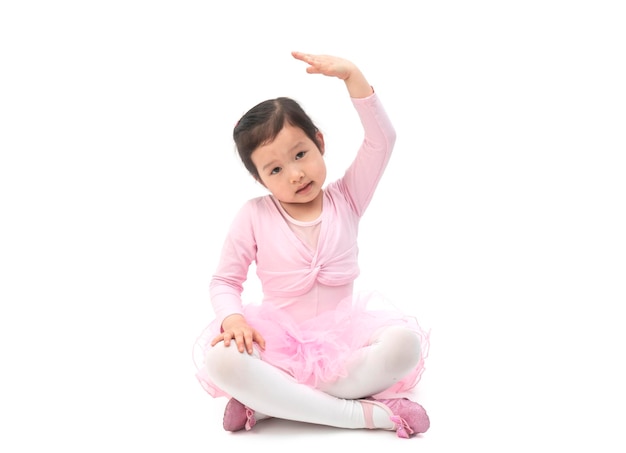 The beautiful little girl is doing gymnastics on a white background