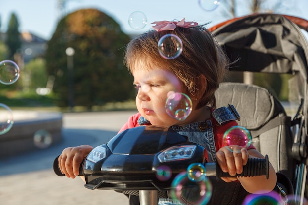 Beautiful little girl sitting on a bike